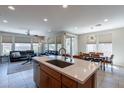 Open concept kitchen with island, stainless steel appliances, and ample counter space at 36131 N Desert Tea Dr, Queen Creek, AZ 85140