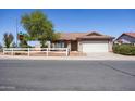 House exterior with a white fence and mature tree in front at 412 E Dartmouth Dr, Casa Grande, AZ 85122