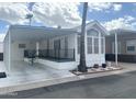 Single wide manufactured home with carport and landscaping at 155 S Limestone Dr, Apache Junction, AZ 85119