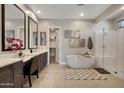 Luxurious bathroom with a soaking tub, walk-in shower, and double vanity at 23060 E Sonoqui Blvd, Queen Creek, AZ 85142