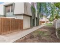 Exterior of building showing walkway and wooden fence at 5921 W Golden Ln, Glendale, AZ 85302