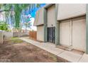 View of building exterior with gated entrance and walkway at 5921 W Golden Ln, Glendale, AZ 85302