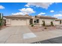 Tan one-story house with a two-car garage and desert landscaping at 14194 W Mountain Laurel Trl, Surprise, AZ 85374