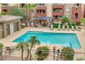 Community pool with lounge chairs and a pergola at 5401 E Van Buren St # 3003, Phoenix, AZ 85008