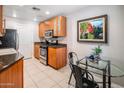 Modern kitchen with wood cabinets, granite counters, and stainless steel appliances at 6900 E Princess Dr # 1136, Phoenix, AZ 85054