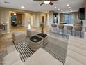 Open living room, kitchen, and dining area with tile floors at 13049 W Redbird Rd, Peoria, AZ 85383