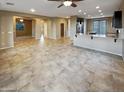 Open concept living area with tile flooring and kitchen access at 13049 W Redbird Rd, Peoria, AZ 85383