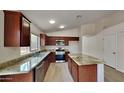 Modern kitchen with granite countertops and stainless steel appliances at 8758 E Obispo Ave, Mesa, AZ 85212
