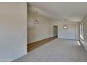 Open living room with vaulted ceilings and neutral carpeting at 8758 E Obispo Ave, Mesa, AZ 85212