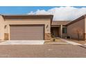 Tan colored home with a two-car garage and walkway at 846 N Pueblo Dr # 126, Casa Grande, AZ 85122