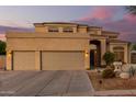 Two-story house with a large driveway and landscaping at 7640 E Snowdon Cir, Mesa, AZ 85207