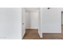 Bright hallway with light wood flooring and ample storage at 6027 E Duncan St, Mesa, AZ 85205