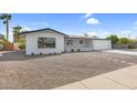 Updated ranch home with a gravel front yard and walkway at 6027 E Duncan St, Mesa, AZ 85205