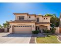 Two-story house with a tan exterior, landscaped lawn, and a two-car garage at 8129 W Ross Ave, Peoria, AZ 85382