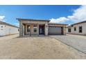 Modern home exterior with stone accents and two car garage at 18209 E Paria Canyon Dr, Rio Verde, AZ 85263