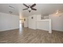 Bright living room with wood-look tile floors at 14715 W Redfield Rd, Surprise, AZ 85379