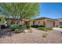 One-story home with attractive desert landscaping and a two-car garage at 19779 N De Grazia Ct, Surprise, AZ 85374