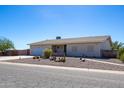 Single-story home with a two-car garage and desert landscaping at 8183 W Raven Dr, Arizona City, AZ 85123
