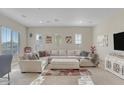 Spacious living room with sectional sofa and large TV at 15201 S 183Rd Dr, Goodyear, AZ 85338