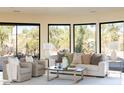 Bright living room with large windows and comfortable seating at 10648 E Greythorn Dr, Scottsdale, AZ 85262