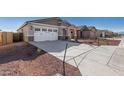 House exterior showcasing a driveway and neighboring homes at 17383 W El Caminito Dr, Waddell, AZ 85355