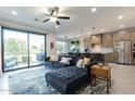 Open-concept living area with kitchen and patio access at 142 E Hearne Way, Gilbert, AZ 85234
