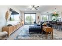 Open concept living room with a sectional sofa and sliding glass door at 142 E Hearne Way, Gilbert, AZ 85234