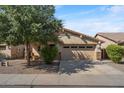 Single story home with a two-car garage and landscaped front yard at 1448 E Poncho Ln, San Tan Valley, AZ 85143