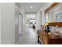 Bright entryway with tile flooring and decorative console table at 41692 W Monsoon Ln, Maricopa, AZ 85138