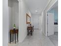Bright and airy entryway with tile flooring, console table, and mirror at 41692 W Monsoon Ln, Maricopa, AZ 85138