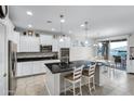 Spacious kitchen featuring white cabinets, granite island, and stainless steel appliances at 41692 W Monsoon Ln, Maricopa, AZ 85138