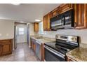 Modern kitchen featuring stainless steel appliances and granite countertops at 3843 W Sahuaro Dr, Phoenix, AZ 85029