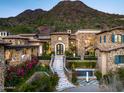 Stone exterior luxury home with large staircase at 11200 E Canyon Cross Way, Scottsdale, AZ 85255