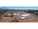 Aerial view of a house under construction, showcasing its framing and surrounding desert landscape at 28021 N 156Th St, Scottsdale, AZ 85262