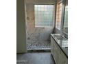 Modern bathroom with double vanity, walk-in shower, and marble tile at 35314 N 31St Ave, Phoenix, AZ 85086