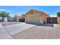 Single story home with two car garage and desert landscaping at 1043 N Agave St, Casa Grande, AZ 85122