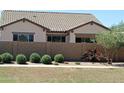 Back exterior view of home with block wall and landscaping at 21042 E Camina Buena Vis, Queen Creek, AZ 85142