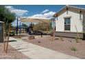 Community playground with shade structure and play equipment at 21042 E Camina Buena Vis, Queen Creek, AZ 85142