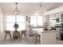 Bright kitchen featuring an island, dining area, and ample counter space at 8216 E Plata Ave, Mesa, AZ 85212