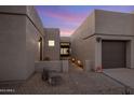 A walkway leads to the front entrance of a contemporary home with a two-car garage at 7056 E Mighty Saguaro Way, Scottsdale, AZ 85266