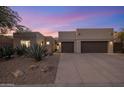 Modern home exterior at dusk with desert landscaping at 7056 E Mighty Saguaro Way, Scottsdale, AZ 85266