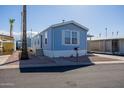 Charming light blue manufactured home with covered carport at 2601 E Allred Ave # Br24, Mesa, AZ 85204