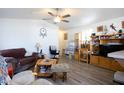 Cozy living room with comfy seating, wood floors, and built-in shelving at 2601 E Allred Ave # Br24, Mesa, AZ 85204