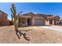 Single-story house with a two-car garage and desert landscaping at 7221 W Globe Ave, Phoenix, AZ 85043