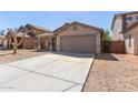 Single-story house with a two-car garage and desert landscaping at 7221 W Globe Ave, Phoenix, AZ 85043
