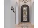 Elegant entryway with ornate door and chandelier at 7232 E Eclipse Dr, Scottsdale, AZ 85266