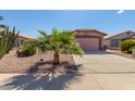 House exterior with a two-car garage and desert landscaping at 1373 E Cherry Hills Dr, Chandler, AZ 85249