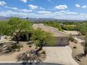 Single-story home with desert landscaping, two-car garage, and mountain views at 26601 N Aguila Rd, Rio Verde, AZ 85263