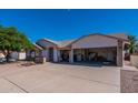 Single-story home with a two-car garage and landscaped front yard at 8217 E Natal Ave, Mesa, AZ 85209