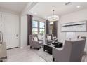 Bright living room with gray seating, a coffee table, and large windows at 18198 W Cielo Grande Ave, Surprise, AZ 85387